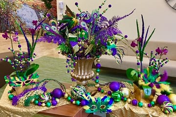Festive Mardi Gras decorations for a table.
